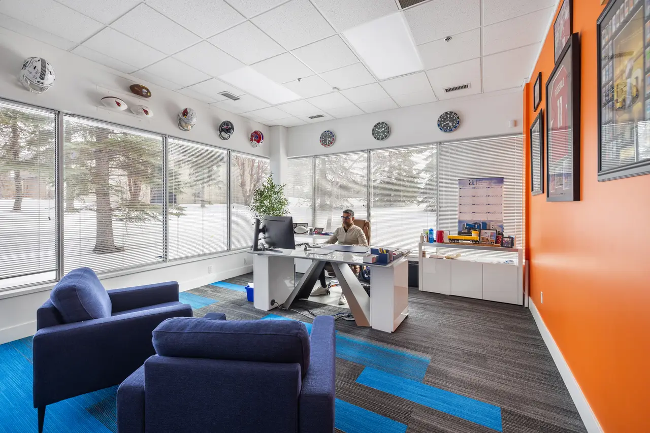 A broker's office with a lounge area and mountain-town views